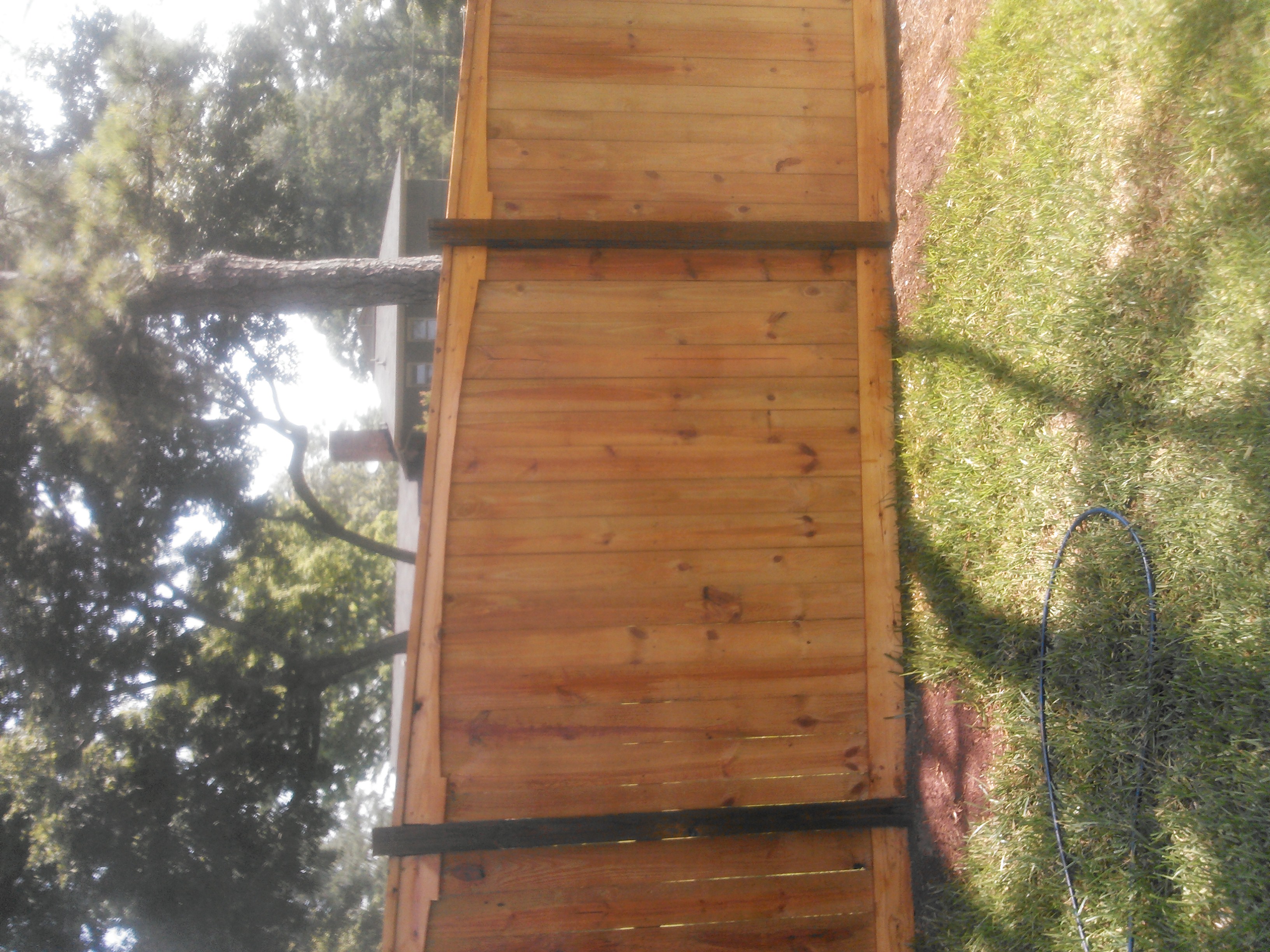 Decorative arched picture frame wood fence with scalloped top detail and trimmed framing