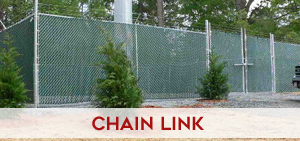 Heavy-duty commercial chain link fencing with barbed wire top securing an industrial perimeter