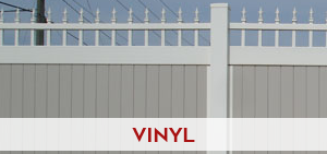 Commercial white vinyl fencing enclosing a large property with consistent panel spacing