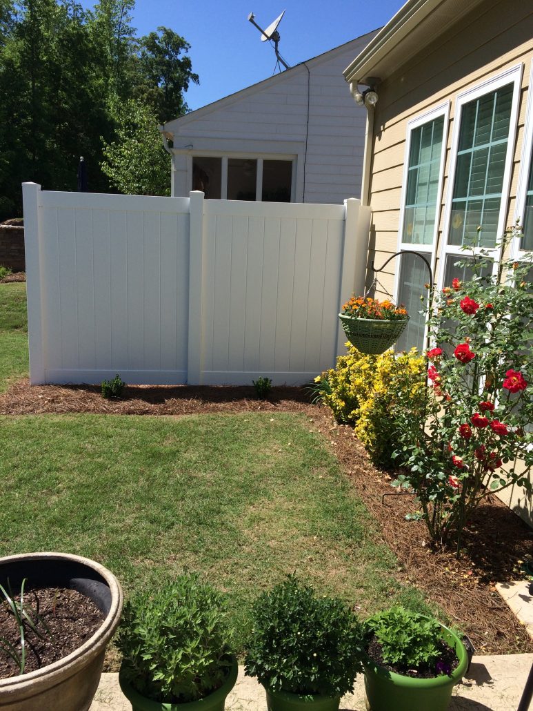 White vinyl privacy fence in a residential backyard in Griffin, Georgia